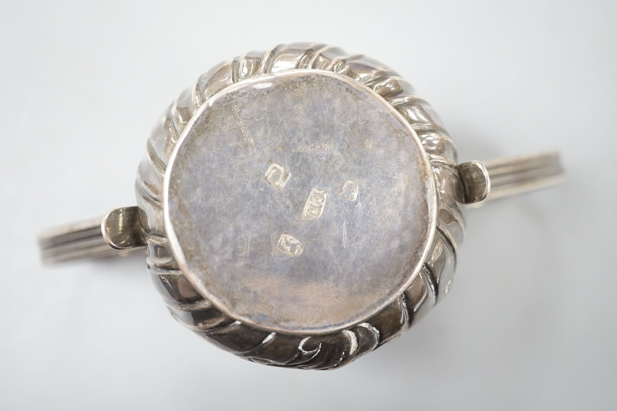 A George III embossed silver porringer, FM, London, 1766, 64mm, 79 grams.